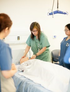Nurse instructor teaching with high-tech mannequin